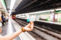 Woman traveler holds Barcelona public transport T-10 ticket in subway