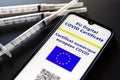 July 13, 2021, Brazil. In this photo illustration the EU Digital COVID Certificate seen on a smartphone screen and vaccine