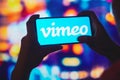 July 6, 2022, Brazil. In this photo illustration, a silhouetted woman holds a smartphone with the Vimeo logo displayed on the