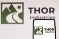 July 5, 2022, Brazil. In this photo illustration, the Thor Industries logo is displayed on a smartphone screen and in the