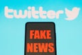 July 13, 2022, Brazil. In this photo illustration, the words `fake news` are displayed on a smartphone with a Twitter logo in th