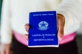 July 4, 2020, Brazil. Woman holds his Brazilian document work and social security Carteira de Trabalho e Previdencia Social