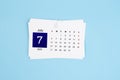 July Calendar 2025 page on blue background Royalty Free Stock Photo