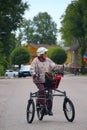 Elderly woman riding a tricycle on the way Royalty Free Stock Photo