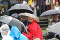 11 JULY 2013 - GARANA, ROMANIA. Scenes and people sitting or walking on the street in a rainy day Royalty Free Stock Photo