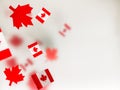 July 1, Happy Canada Day. Red maple leaves and flags on a transparent foggy background. A multi-tiered photo, a Memorial