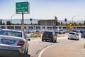 July 13, 2019 Hayward / CA / USA - Freeway entrance in East San Francisco bay area; BART Bay Area Rapid Transit train passing in