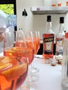 Five wine glasses of orange mixed cocktails with Aperol bottles in background Royalty Free Stock Photo