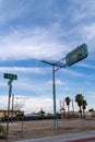 Old rusted vintage sign for the abandoned and closed Vegas Court Motel against a blue sky