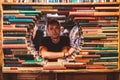 Young man reading a book in the Last Book Store in LA. Royalty Free Stock Photo