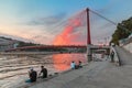 Cityscape of Lyon city at sunset with red footbridge leading to Courthouse Palais de Justice over