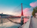 Cityscape of Lyon city at sunset with red footbridge leading to Courthouse Palais de Justice over