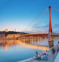 Cityscape of Lyon city at sunset with red footbridge leading to Courthouse Palais de Justice over