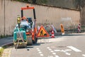 The road is closed for reconstruction, on the roadside parked small rollers pavers