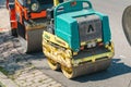 The road is closed for reconstruction, on the roadside parked small rollers pavers