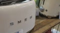 July 2021 Milan, Italy: Smeg kitchen appliances on the store shelf close-up. Smeg logo icon