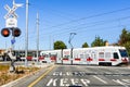 July 16, 2019 Mountain View / CA / USA - Waiting at a barrier for a VTA Train to pass in south San Francisco bay; VTA Light Rail