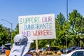 July 26, 2019 Palo Alto / CA / USA - Protester holding a sign with the message `Support our immigrants and workers`