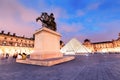 Equestrian statue of king Louis XIV in the courtyard of the Louvre museum at evening time