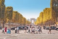 pedestrians crossing over the Avenue Champs Elysees at the background of Arch de Triumph