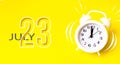 July 23rd. Day 23 of month, Calendar date. White alarm clock with calendar day on yellow background. Minimalistic concept of time