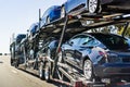 July 4, 2019 Redwood City / CA / USA - Car transporter carries Tesla Model 3 new vehicles along the highway in San Francisco bay