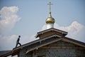 July 11, 2020, Russia, Magnitogorsk. A man walks along the roof of a church under construction to a dome with a cross. The path to