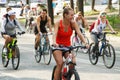 July 27, 2019, Russia, Magnitogorsk. A smiling girl rides a bicycle with a group of cyclists - participants in an open bike ride