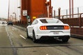 July 4, 2019 San Francisco / CA / USA - White Ford GT Mustang travelling on Golden Gate Bridge; rear view