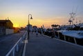 July 2022 Senigallia, Italy: view of the harbor on the sunset over the yachts and boats, people walking. Urban view. City postcard
