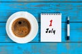 July 1st. Day of the month 1 , calendar on business workplace background with morning coffee cup. Summer concept. Hello
