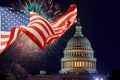 July 4th Independence day show cheerful fireworks display on the U.S. Capitol Building in Washington DC USA with American flag Royalty Free Stock Photo