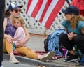 July 4th, 2022 Larkspur California USA, Corte Madera Larkspur 4th of July Parade, young bystander sitting with adult