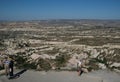 tourist looking through coin operated binoculars sightseeing scenic, Uchair, castle, Cappadocia, Turkey