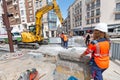 Woman foreman supervises and manages the work of colleagues to repair the road