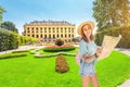 Happy asian Woman with map travelling in baroque garden park in Schonbrunn imperial palace. Tourism Royalty Free Stock Photo