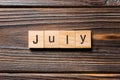 July word written on wood block. July text on wooden table for your desing, Top view concept Royalty Free Stock Photo