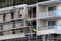 July 15, 2021. Workers disassembling scaffolding on now completed top floors of home unit block at 56-58 Beane St