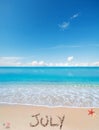 July written on a tropical beach Royalty Free Stock Photo