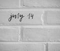 July 14 WRITTEN ON WHITE PLAIN BRICK WALL