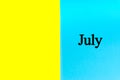 JULY written words on blue and yellow background.