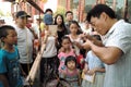 On July 31, 2014 in xi 'an wild goose pagoda scenic area in the square, a folk artists intently rub blowing the calf, lamb, small