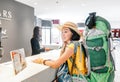 Happy woman with backpack checking in at EUROSTARS hotel reception Royalty Free Stock Photo