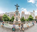 People, tourists at the Spain Square in Zaragoza resting near fountain