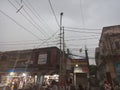 a jumble of cables and meters installed outside in a local market