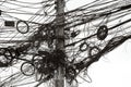 A jumble of electrical and telephone wires attached to a pole in Bangkok, Thailand Royalty Free Stock Photo