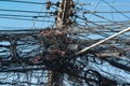 A jumble of electrical and telephone wires attached to a utility pole in Thailand Royalty Free Stock Photo