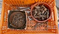 Jumble of old rusty nails and hand tools in a orange plastic box. Royalty Free Stock Photo