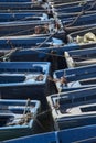 jumble of small blue fishing bats huddled together in port