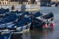 jumble of small blue fishing boats huddled together in port